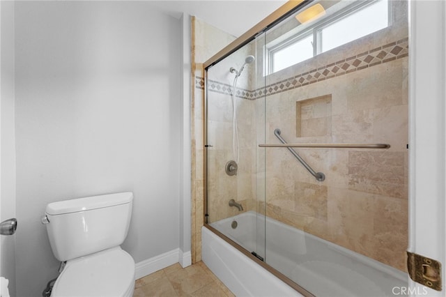 bathroom featuring tile patterned flooring, toilet, and enclosed tub / shower combo