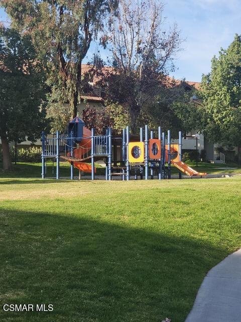 view of playground with a lawn