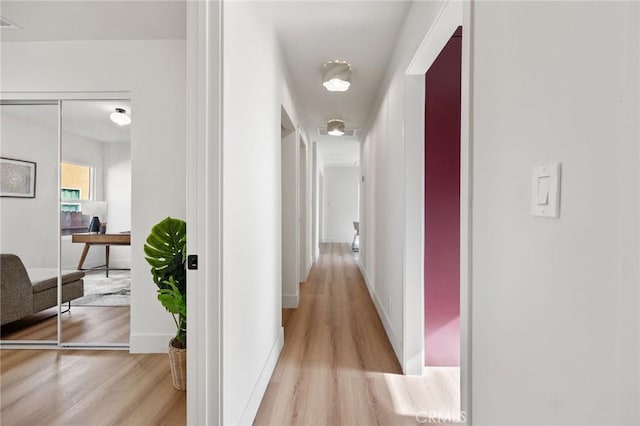 corridor with light hardwood / wood-style flooring