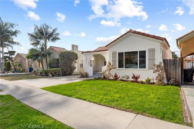 mediterranean / spanish house featuring a front lawn