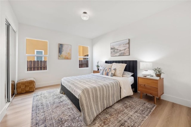 bedroom with light wood-type flooring and a closet