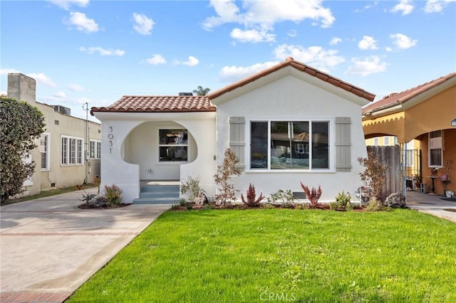 mediterranean / spanish home featuring a front yard