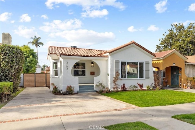 mediterranean / spanish-style house featuring a front lawn