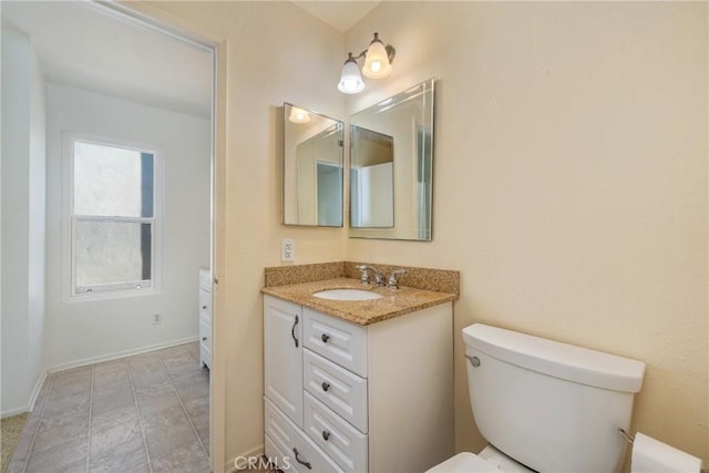 bathroom with toilet and vanity