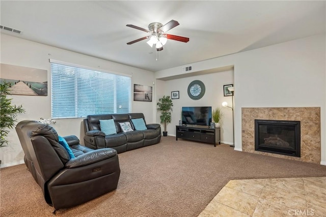 living room featuring ceiling fan and carpet