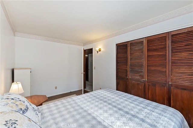 bedroom with a closet and ornamental molding