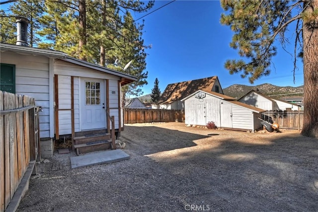 view of yard with a storage shed and a mountain view