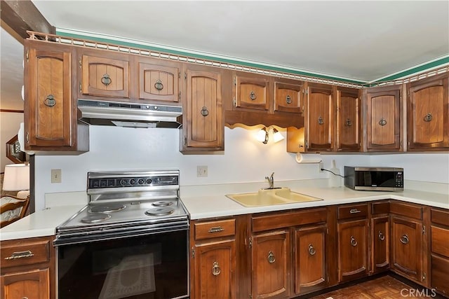 kitchen with dark parquet floors, black range with electric stovetop, and sink