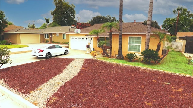 ranch-style house with a garage and central AC unit