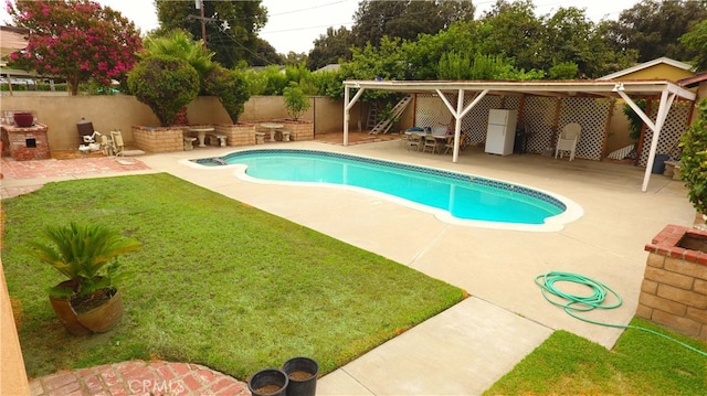 view of pool with a lawn and a patio