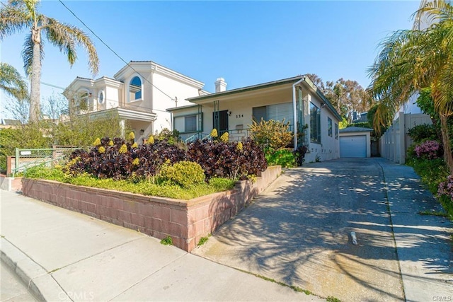 view of front of house with a garage and an outdoor structure