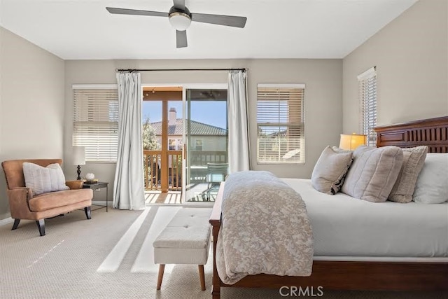 carpeted bedroom featuring ceiling fan, access to exterior, and multiple windows