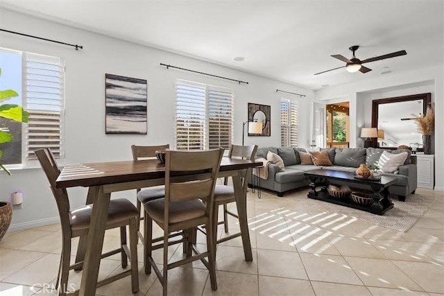 tiled dining area featuring ceiling fan