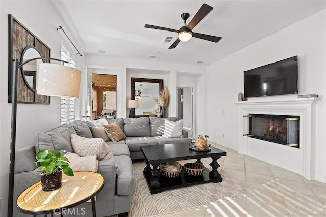 tiled living room with ceiling fan