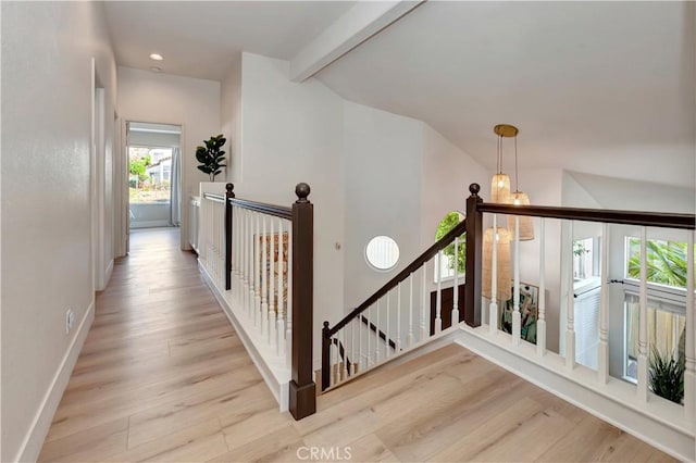 hall featuring lofted ceiling with beams and light wood-type flooring