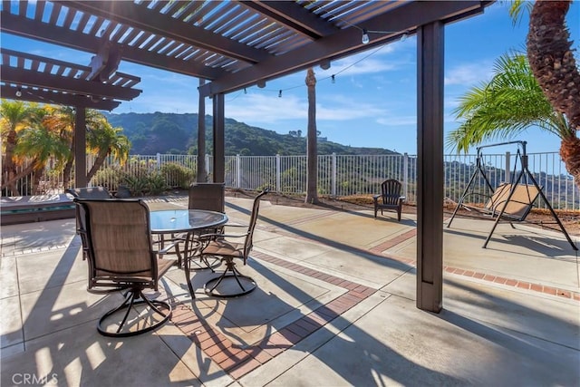 view of patio / terrace featuring a pergola and a mountain view