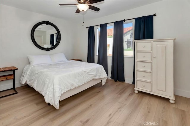 bedroom with ceiling fan and light hardwood / wood-style flooring