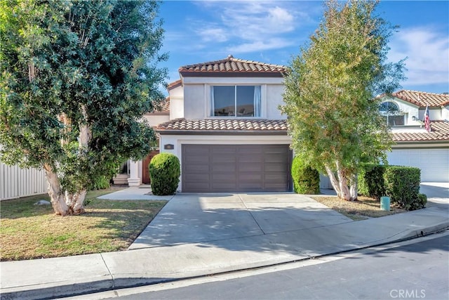 mediterranean / spanish-style home with a garage