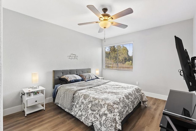 bedroom with dark wood-type flooring and ceiling fan