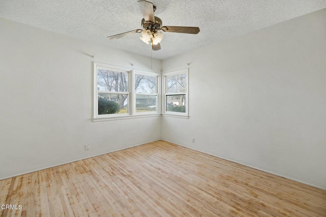 spare room featuring a textured ceiling, ceiling fan, and light hardwood / wood-style flooring