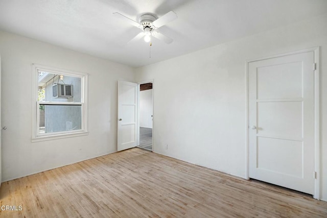 unfurnished bedroom with ceiling fan, cooling unit, and light hardwood / wood-style flooring