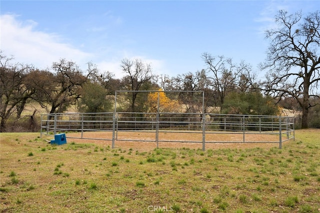 view of community featuring a rural view and an outdoor structure