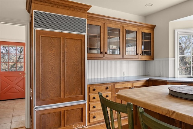 kitchen with paneled refrigerator and light tile patterned floors