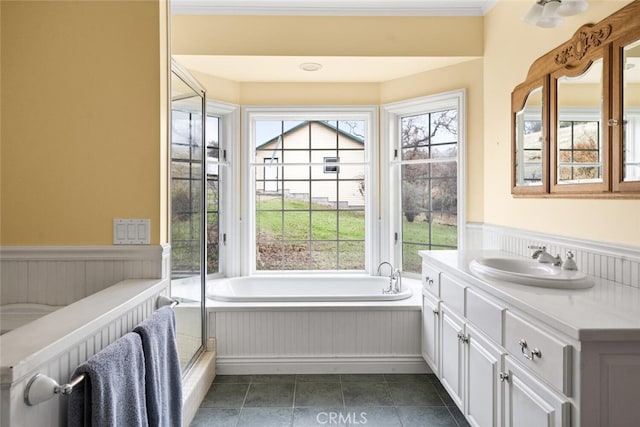 bathroom with vanity, plenty of natural light, a tub, and radiator heating unit