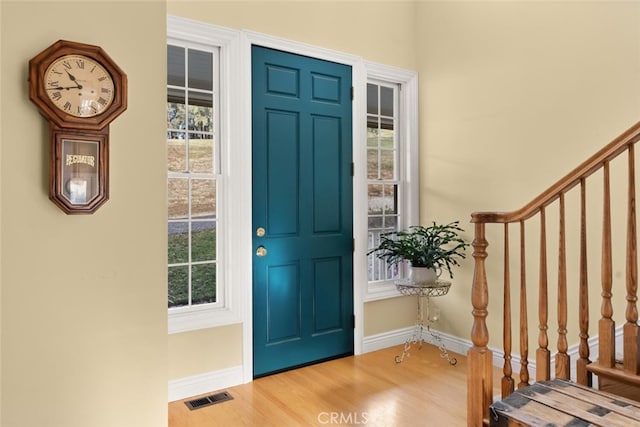 entrance foyer featuring a healthy amount of sunlight and hardwood / wood-style flooring