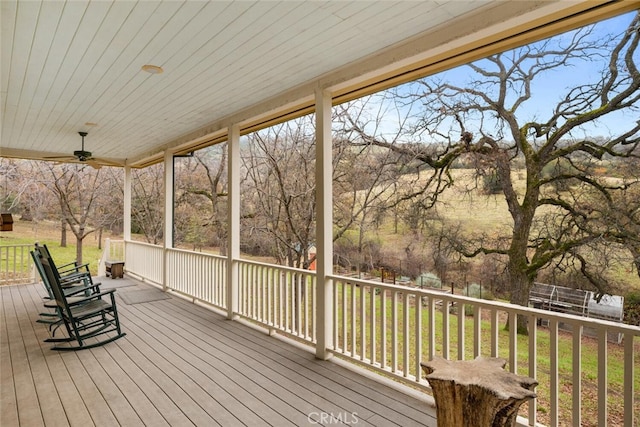 deck with ceiling fan and a lawn