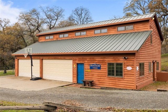 log home featuring a garage and an outbuilding