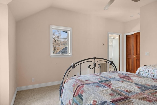 bedroom featuring ceiling fan, vaulted ceiling, and carpet floors