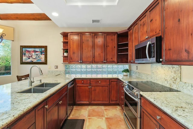 kitchen with light stone countertops, appliances with stainless steel finishes, decorative backsplash, sink, and light tile patterned floors