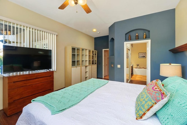 bedroom featuring ceiling fan, ensuite bathroom, and hardwood / wood-style flooring