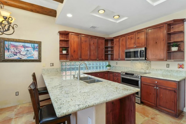 kitchen with a kitchen breakfast bar, appliances with stainless steel finishes, kitchen peninsula, and sink