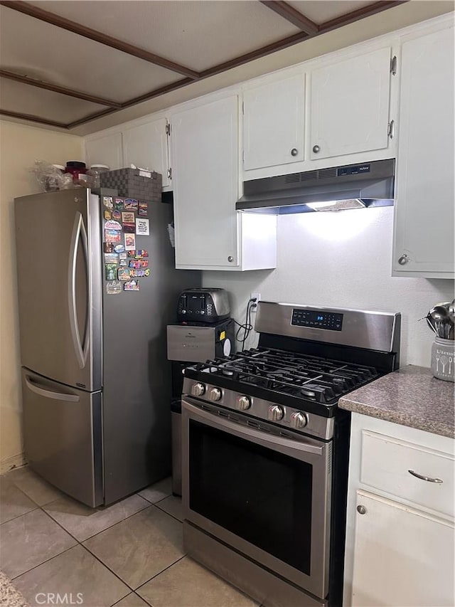 kitchen with white cabinetry, light tile patterned floors, and stainless steel appliances