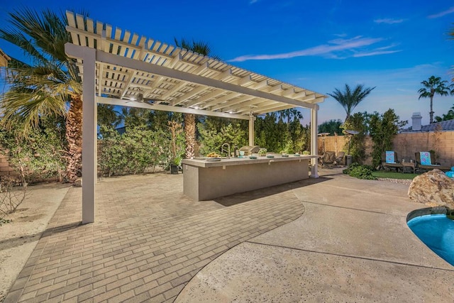 view of patio featuring a bar and a pergola