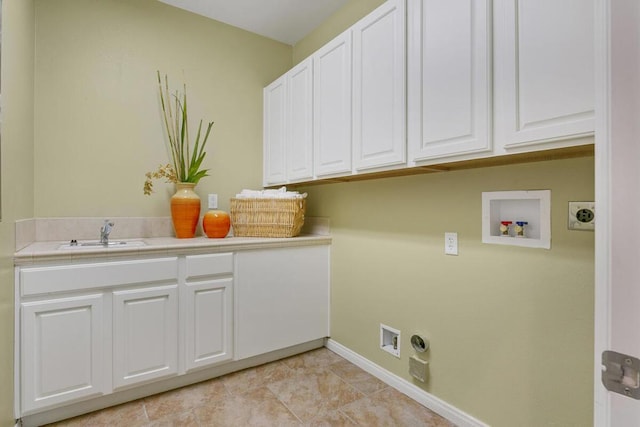 laundry room with cabinets, hookup for a washing machine, and sink