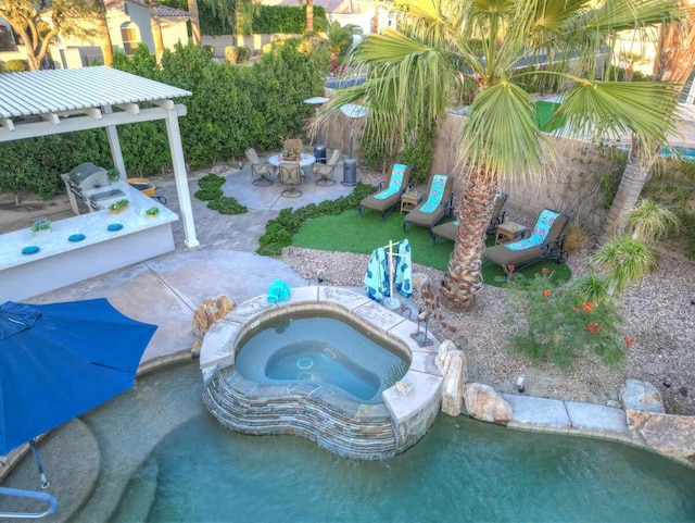 view of pool featuring an in ground hot tub and a patio area