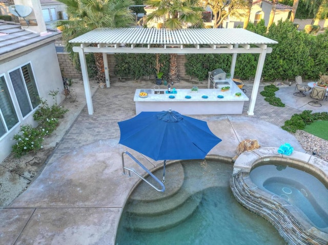 view of pool featuring an in ground hot tub and a patio