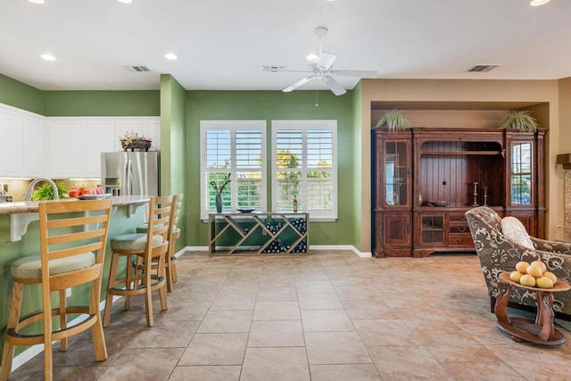 tiled dining room with ceiling fan