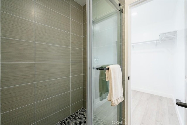 bathroom featuring a shower with door