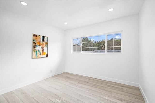 empty room with light hardwood / wood-style floors