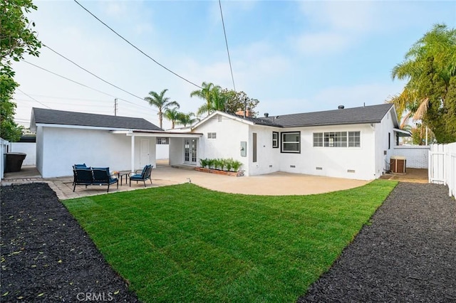 back of property with a patio, an outdoor hangout area, a lawn, and central air condition unit