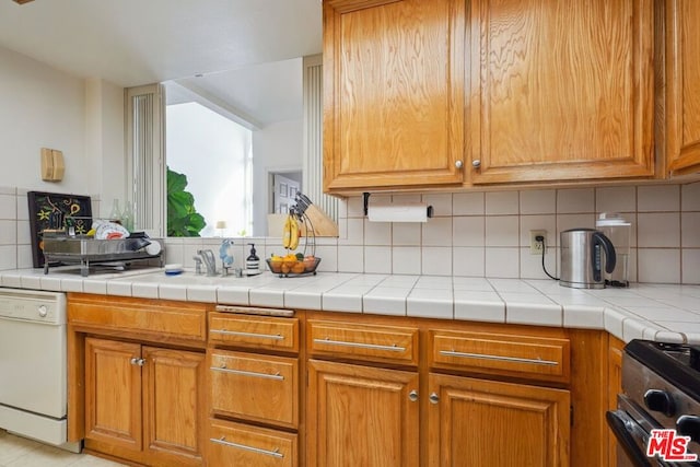 kitchen featuring dishwasher, backsplash, and black electric range