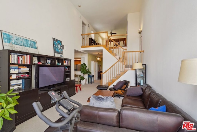 living room with carpet floors and a high ceiling