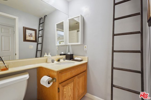 bathroom featuring toilet and vanity