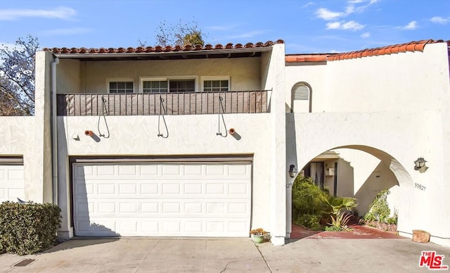 view of front of house with a balcony and a garage