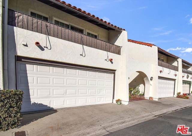 view of front of property with a balcony and a garage