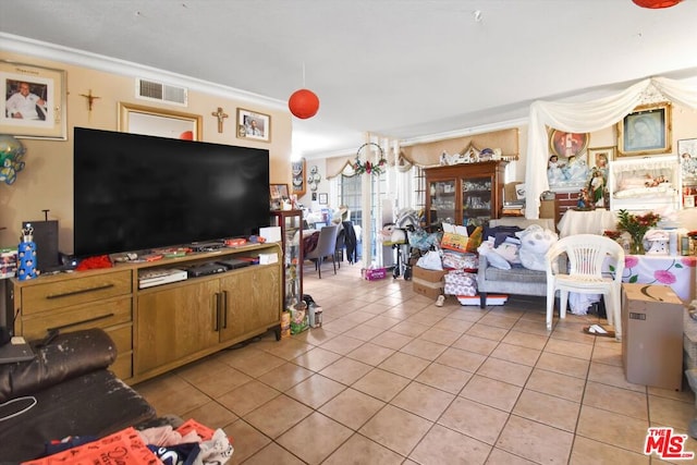 living room with light tile patterned floors and crown molding